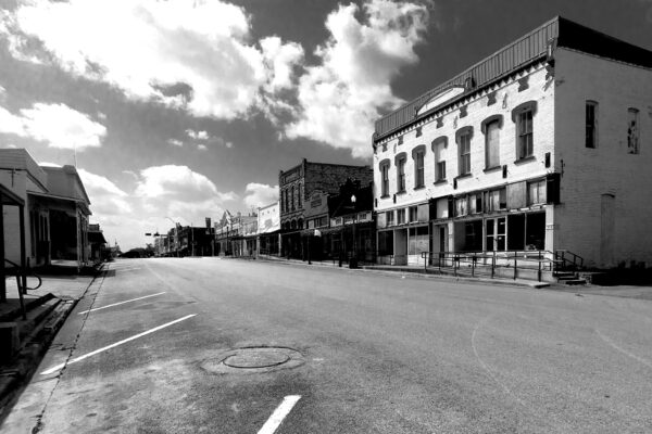 A black and white photo of the main street of a small town in Texas.